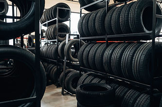 stacked-black-rubber-tires-on-metal-racks-inside-a-2026-04-29-01-25-17-utc.JPG