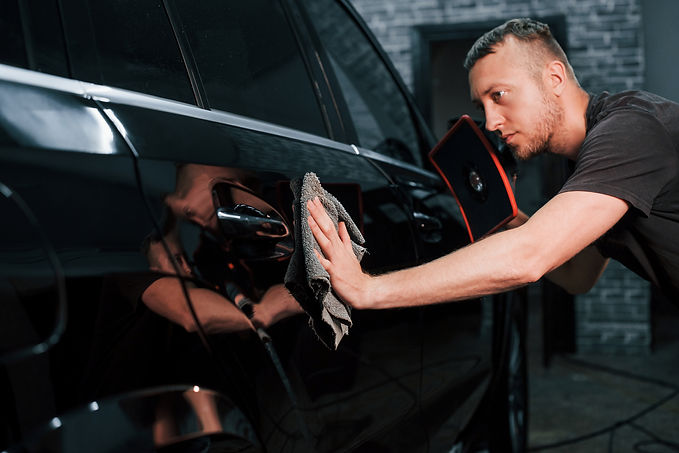 man-detailing-modern-car-with-soft-cloth-2026-03-24-05-14-41-utc.jpg
