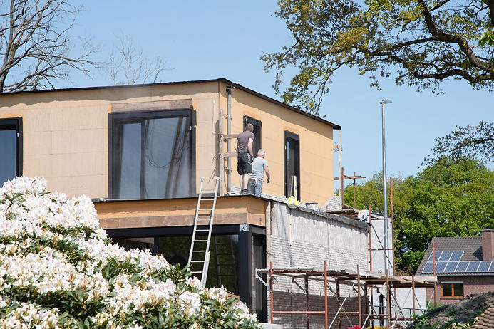 construction-workers-on-roof-inspecting-new-buildi-2026-03-20-03-03-19-utc.jpg