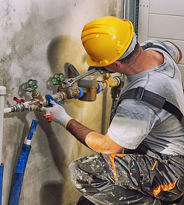 Plumber fixing pipe