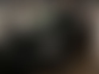 A black KIA EV6, in the rain and dark.