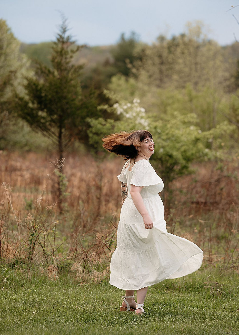 Temple University Graduate dances in the grass during her photo session in Bucks County PA 