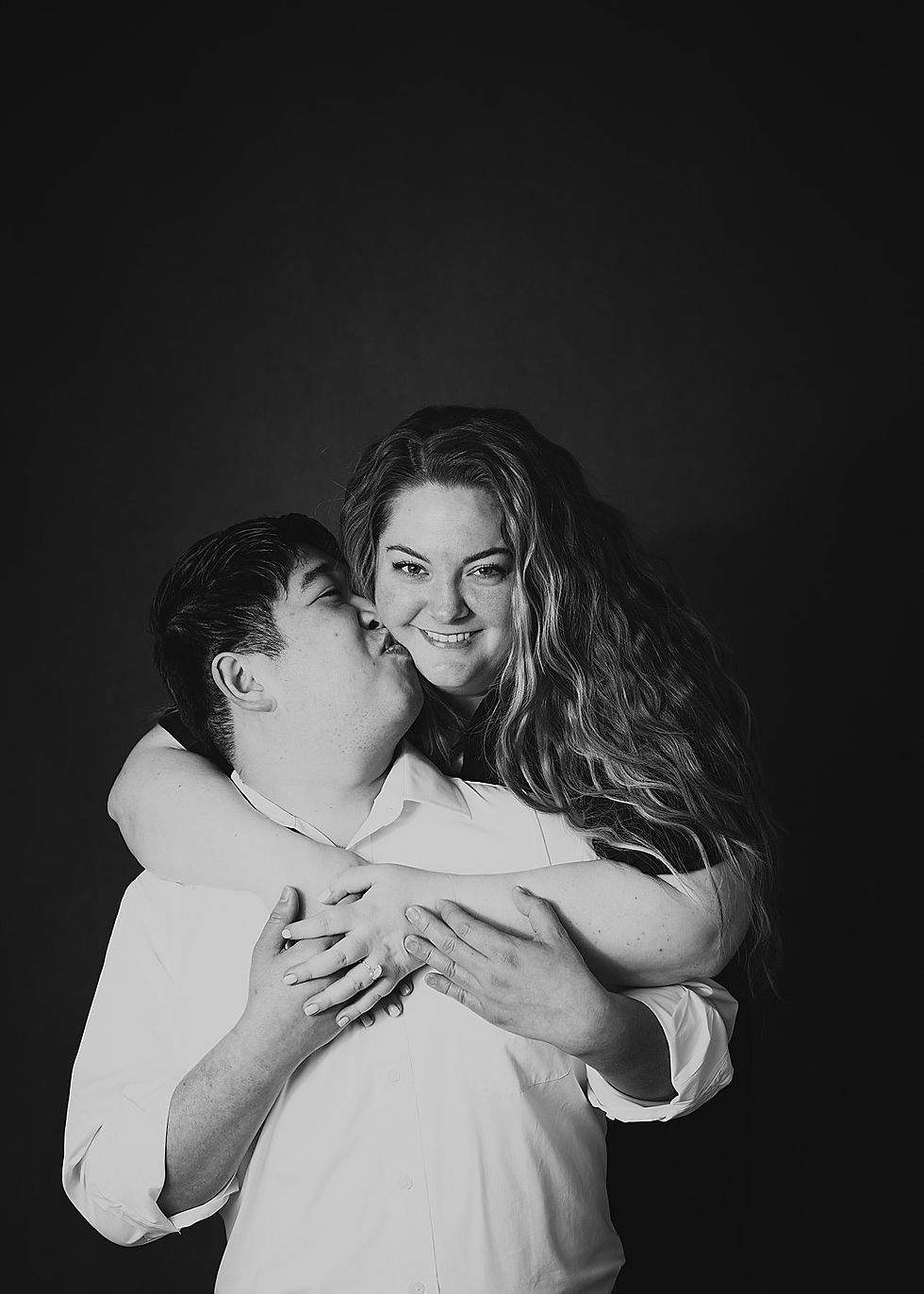 woman wraps arms around her fiance during their Doylestown portrait studio session