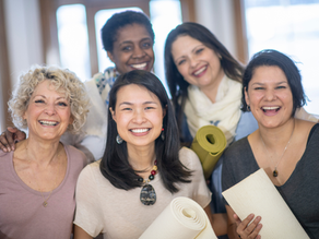 Five women smiling to camera.