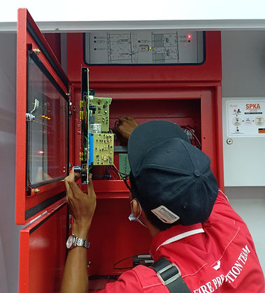 Fire Infinity technician servicing a fire alarm panel