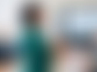 A woman in a green blazer presents in a boardroom with colleagues around a table. A screen shows a "Quarterly Growth Strategy" chart.