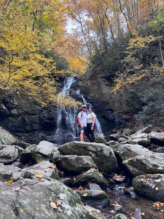 A couple standing in front of Spruce Flats Falls