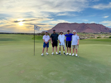 A group of guys and their caddy after their golf round at Black Desert Resort