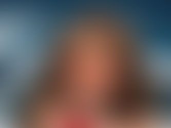 Sexy Maya with green eyes and a sensual look in a minimal bikini touching herself.