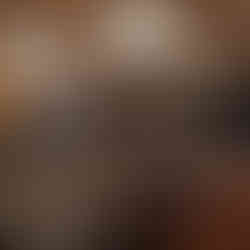 Event staff arranging chairs and tables in a grand ballroom for an upcoming Be Bright Events conference, ensuring a welcoming atmosphere for attendees.