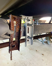 a rusty bunk bracket next to a new one