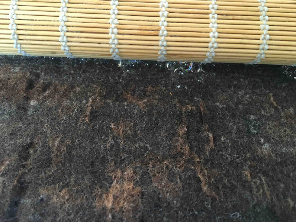 Partly felted Shetland fleece rolled into a bamboo felting mat