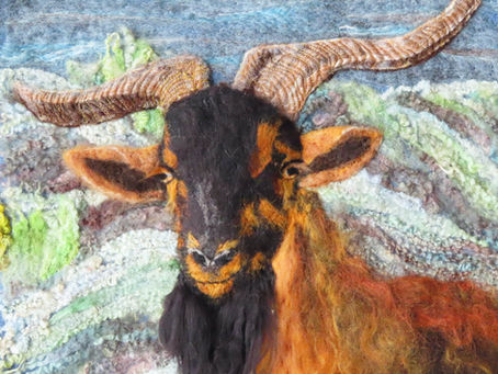 Fibre art portrait of a goat in a Spanish mountain landscape
