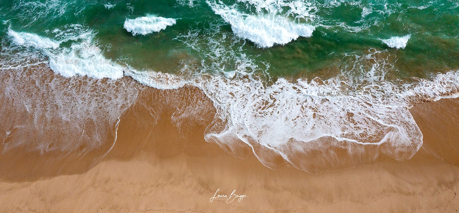 Aerial image of waves and sand