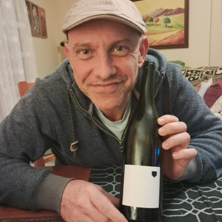 Ivan in Tenerife, holding up a bottle of Vicky Torres, Vino de la Isla.