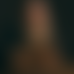 Raúl Pérez, sitting down, with a glass of red wine in his hand.