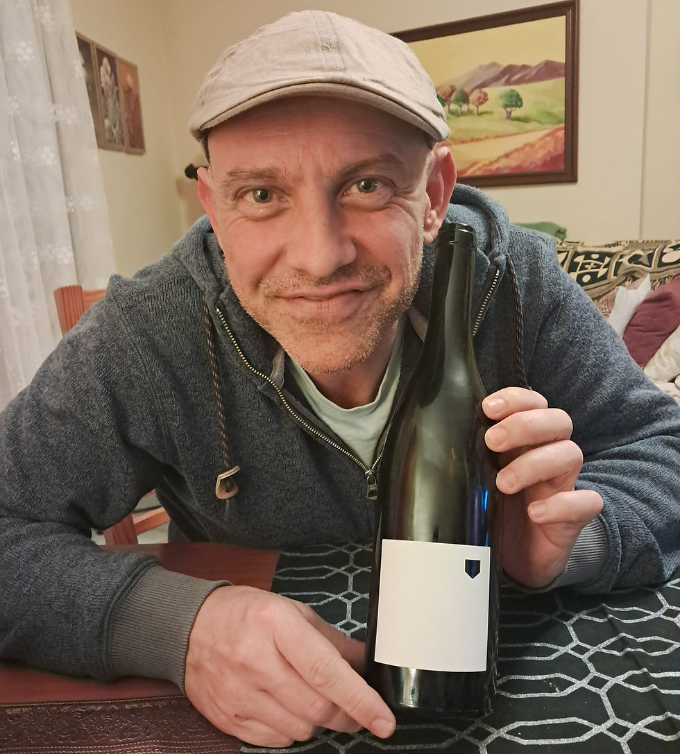 Ivan in Tenerife, holding up a bottle of Vicky Torres, Vino de la Isla.