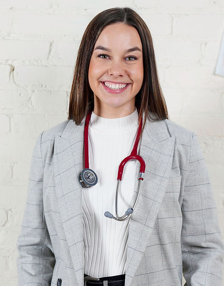 Dr. Lucyshen, a naturopath, smiling in her women's health naturopathic clinic in Kelowna.