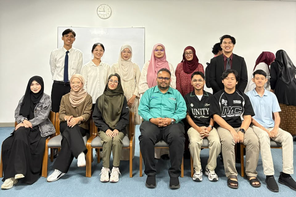 Group photo with Prof. Faisal seated at the centre of the front row, alongside postgraduate students, with degree students standing proudly behind.