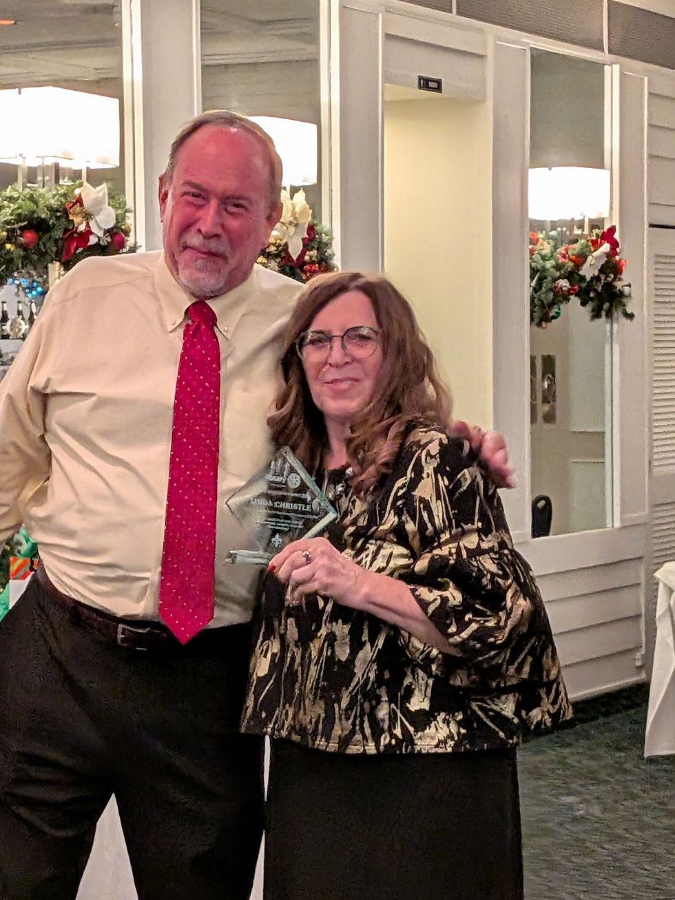 Left David Bramley, Club President, presenting an award to Linda Christie