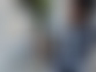 A man in a black vest measures a window frame on a concrete wall with a tape measure. Trees and a fence are visible in the background. The image was taken by HB Design and Engineering in St. Petersburg, Florida, and its used in the blog to represent architecture services, architectural design.