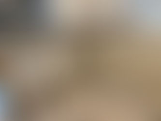 Kitchen under renovation with drywall removed, showing exposed studs and wiring. Debris on tile floor. White cabinets, microwave above. Mood: messy. The picture was taken by Built with Love of a kitchen renovation in St. Petersburg, Florida. The image is used in the blog to represent kitchen renovator near me.