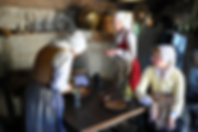 photo of pilgrim women working at a kitchen table