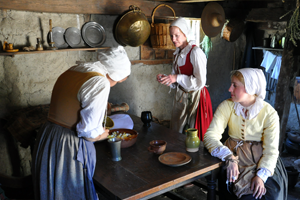photo of pilgrim women working at a kitchen table
