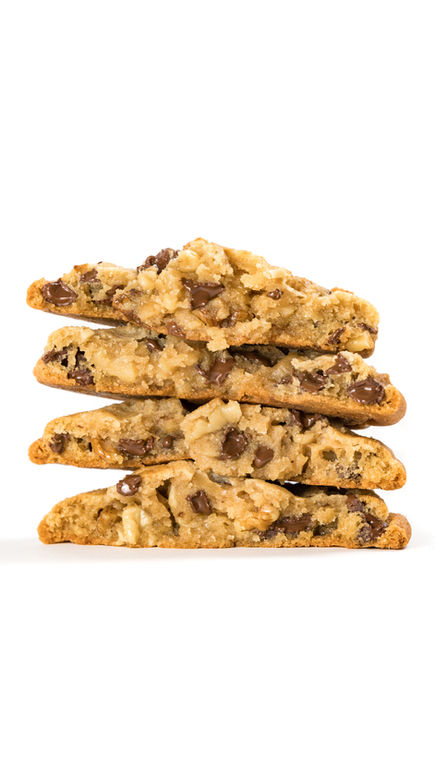 Chocolate chip cookies standing upright in a row on a styled surface, creating visually striking content for branding and soc