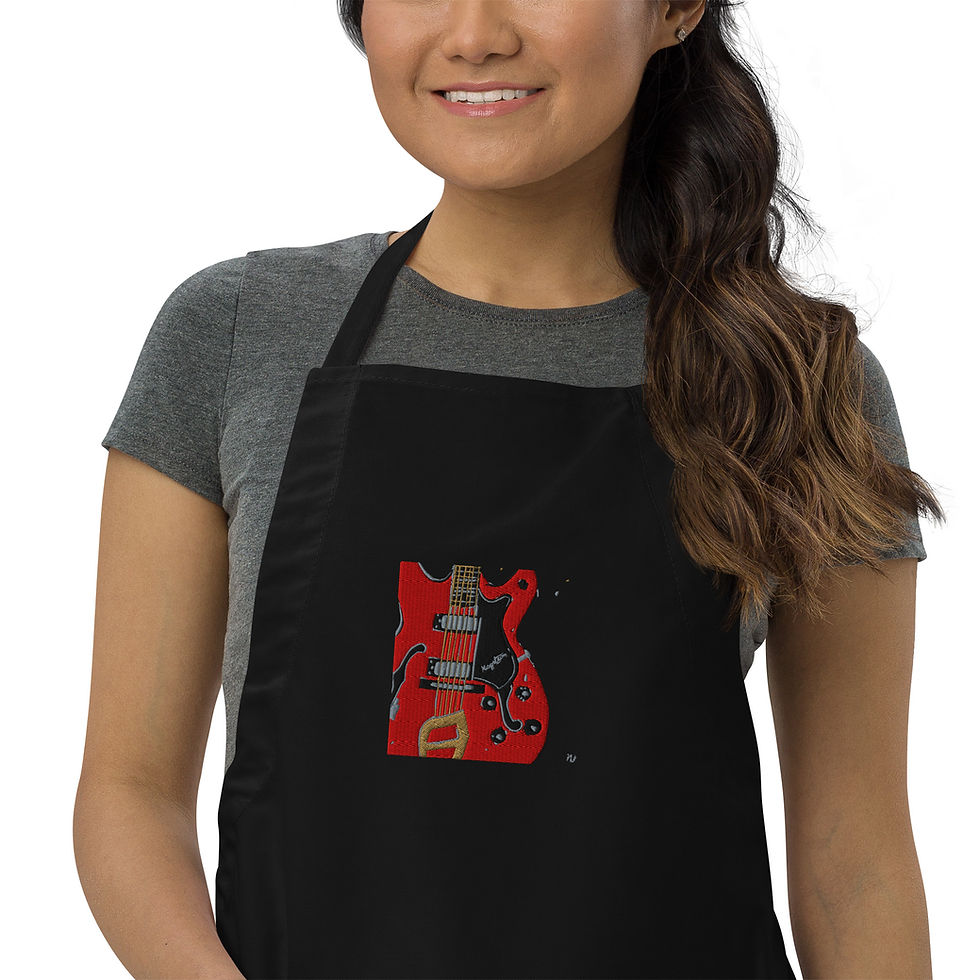 Woman wearing black apron with red Hagstrom guitar embroidery. Gift It Art