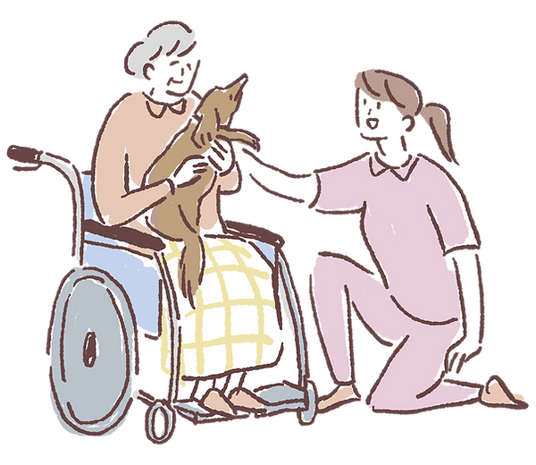 スタッフと車いすの利用者と犬