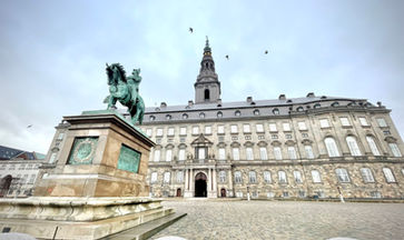 Borsen palace in Copenhagen with a statue of a man on a horse in front of it