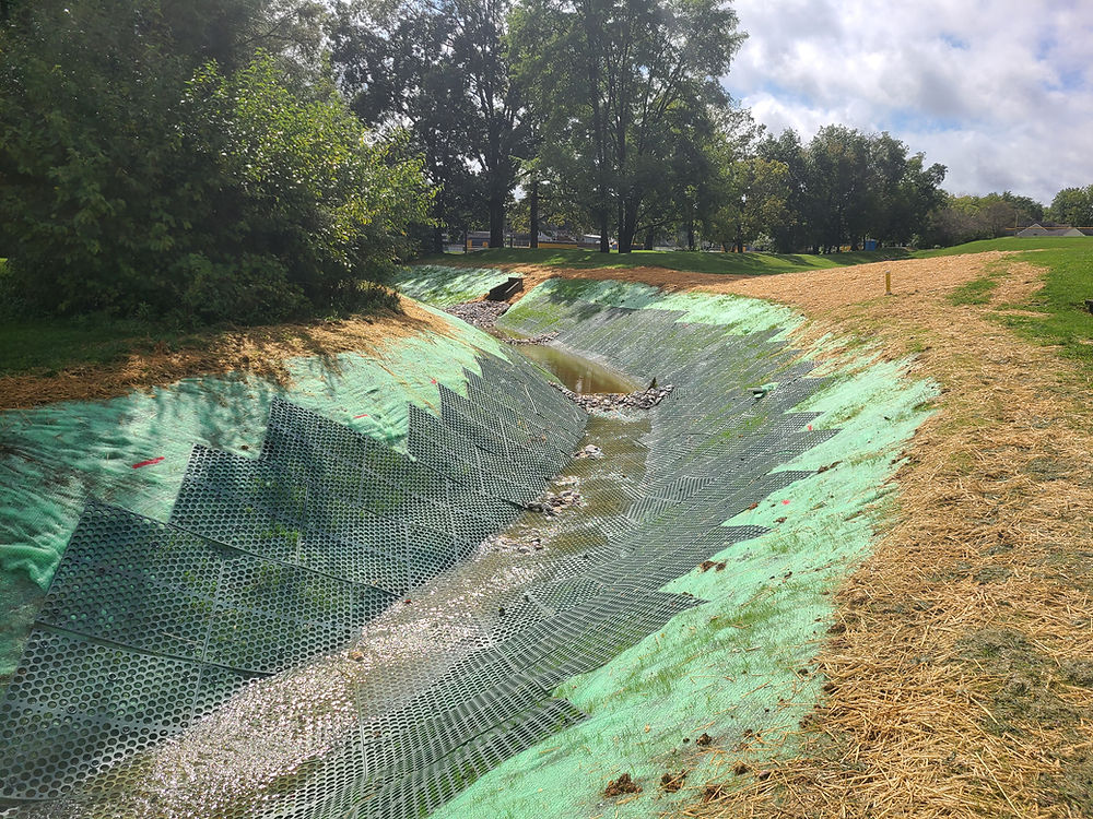 Stabilized drainage channel with erosion control matting and stormwater management system