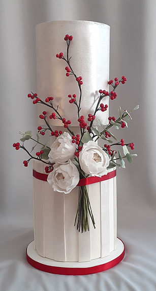 two tier winter wedding cake with branches of red berries