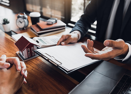 Insurance broker reviewing paperwork on a clipboard.