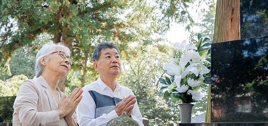 お墓参りをするシニア夫婦