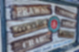 Cockles and mussels image of display board on Brighton pier