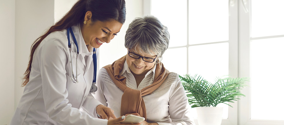 Caring doctor teaches female patient to use mobile healthcare app Retired lady sitting in