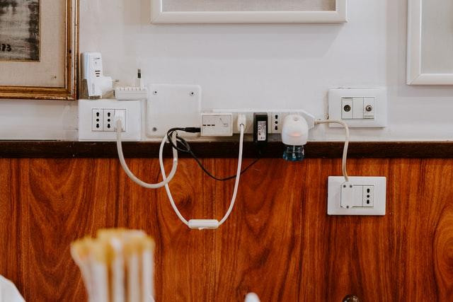 Different charges and cables plugged into different wall sockets