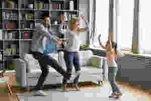 Mom and Dad dancing with young daughter