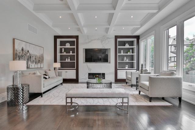 Large modern living room with a tow of bookshelves and a wall-mounted tv between them