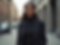 Portrait-photography of a confident Black woman professionally dressed, standing against a