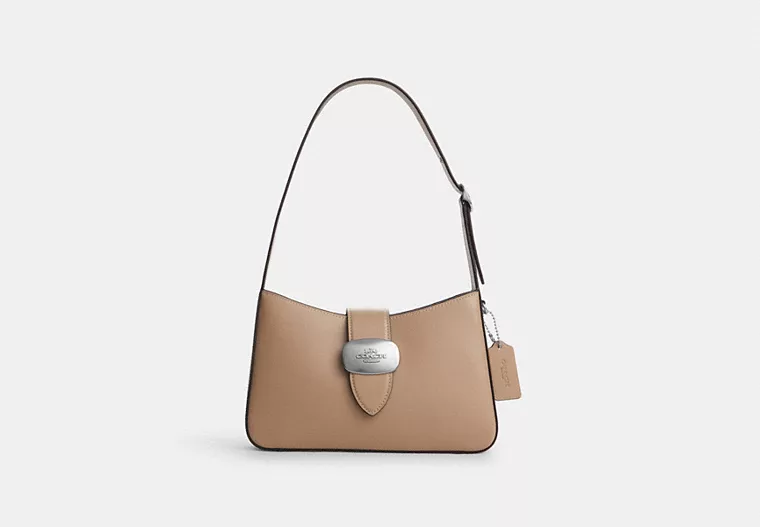 A tan leather shoulder bag by Coach with silver hardware that exudes vintage chic on a budget! Great gift for loved ones this festive season.