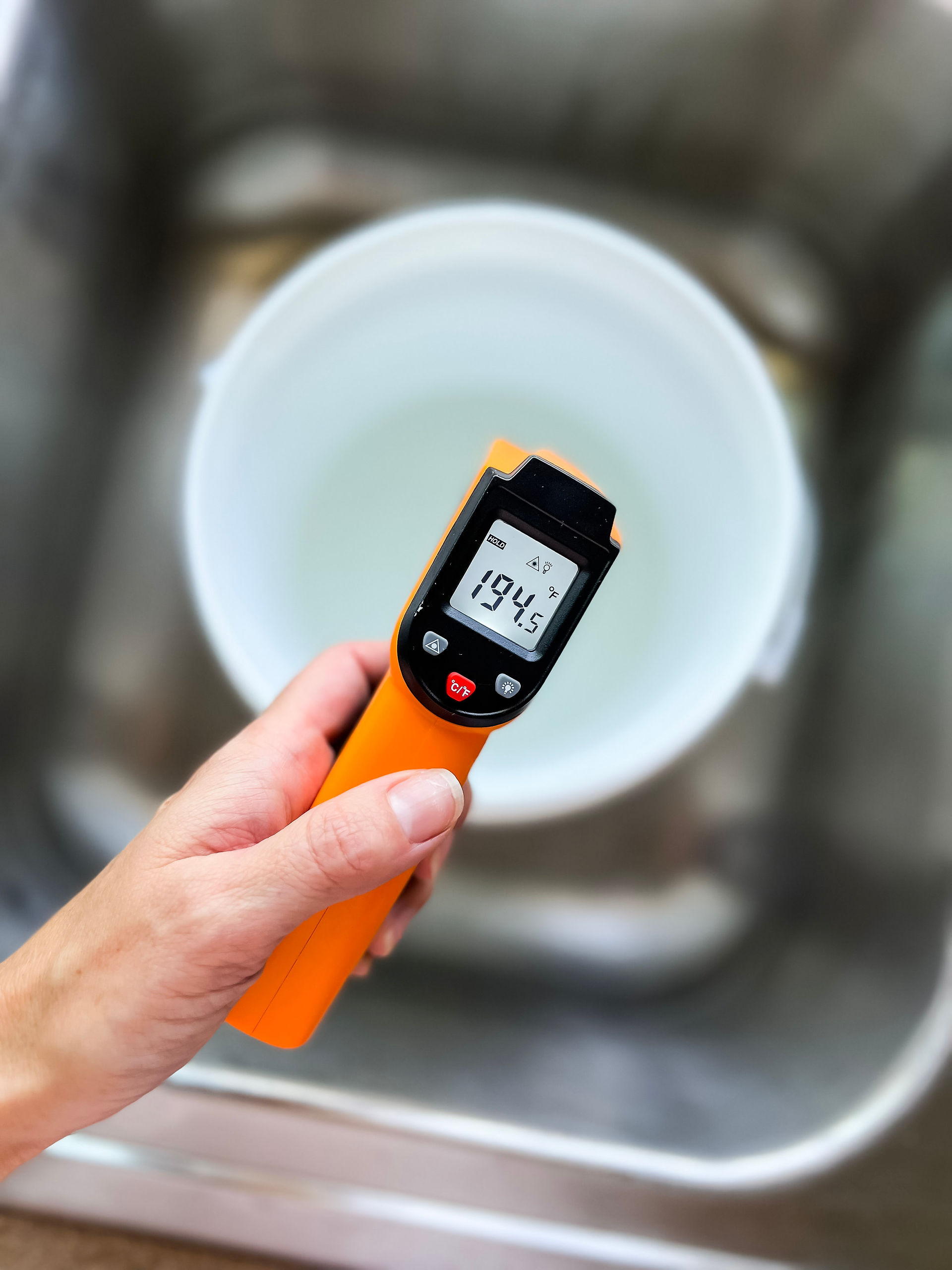 infrared temperature gun taking temperature of lye water