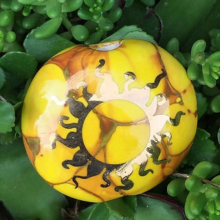 Ancient Creations ceramic spoon hand pipes, one hitter bats, chillums, and smoking stones with real gold sunshine designs hand painted around the bowls.