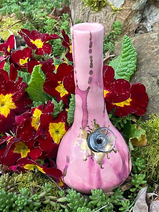 Ancient Creations Ceramics mini bing pipe in pink, with gold sunshine design around the bowl.