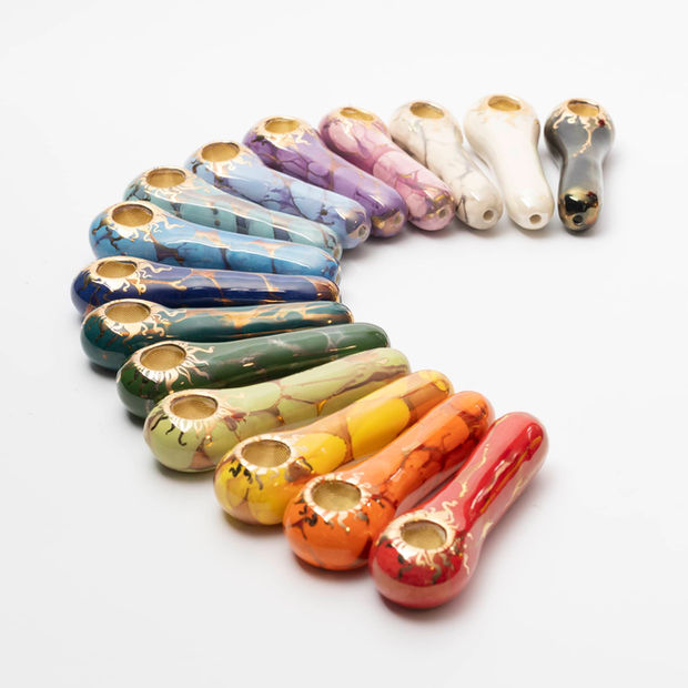A rainbow of Ancient Creations solid ceramic hand pipes with brass screens installed.