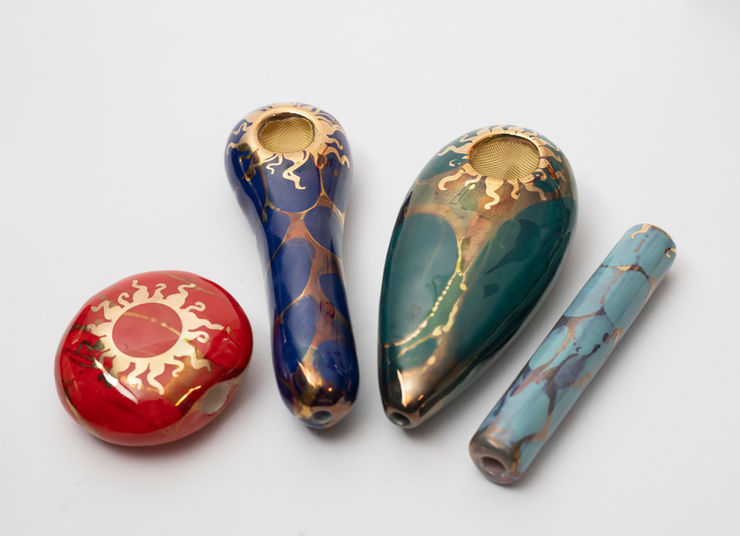 A wholesale display of Ancient Creations 100% handmade hand pipes, palm pipes smoke stones, and one hitter bats. Ready to stock the shelves of your smoke shop, head shop, or dispensary.