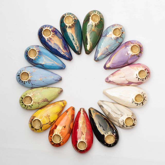 An Ancient Creations Palm Pipe rainbow display in a circle pattern.