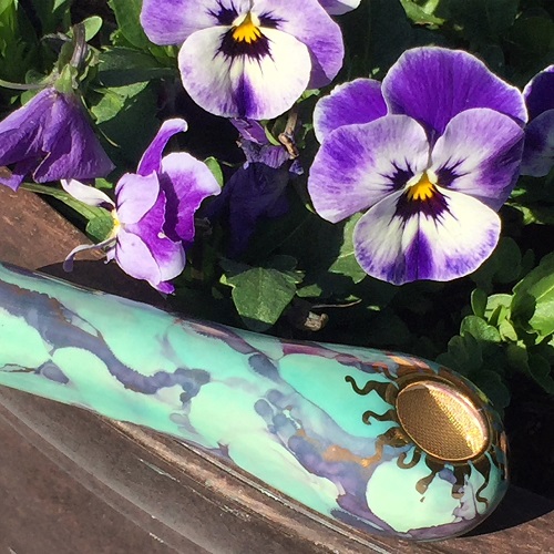 Ancient Creations Spoon pipe in iced mint with gold with pansy flowers in background